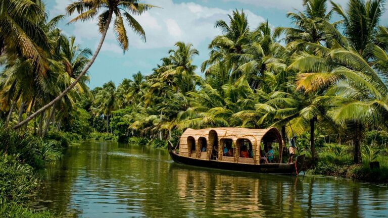 Rice barge sailing through Kerala's backwaters.